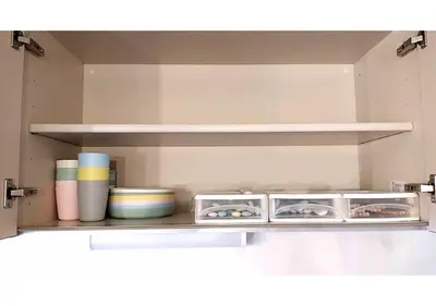 a shelf in a kitchen with bowls and plates at GLAMPEACE\u845b\u98fe\u30fb\u56db\u30c4\u6728 in Tokyo