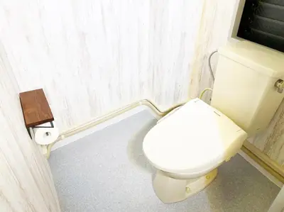a bathroom with a toilet and a roll of toilet paper at GLAMPEACE\u845b\u98fe\u30fb\u56db\u30c4\u6728 in Tokyo