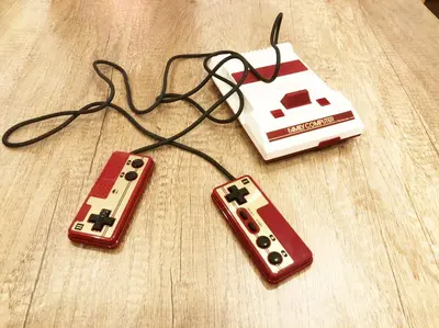 two video game controllers and a nintendo wii game console at GLAMPEACE\u845b\u98fe\u30fb\u56db\u30c4\u6728 in Tokyo