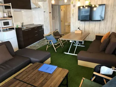 a living room with a couch and a table at GLAMPEACE\u845b\u98fe\u30fb\u56db\u30c4\u6728 in Tokyo