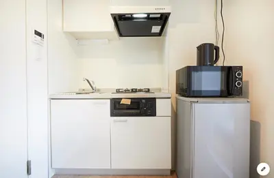 a kitchen with a sink and a microwave and a refrigerator at Marvelous Kinshicho - Vacation STAY 12954v in Tokyo