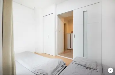 a white room with two beds and a mirror at Marvelous Kinshicho - Vacation STAY 12954v in Tokyo