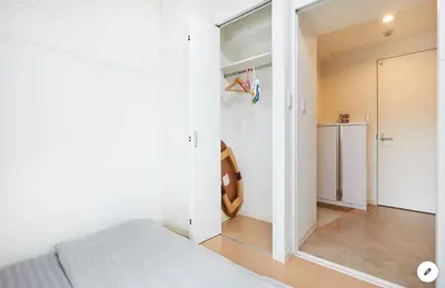 a bedroom with white walls and a bed and a mirror at Marvelous Kinshicho - Vacation STAY 12956v in Tokyo
