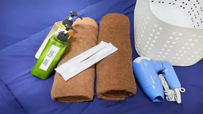 a pair of brown towels on a bed with a bottle at Marvelous Kinshicho - Vacation STAY 12770v in Tokyo
