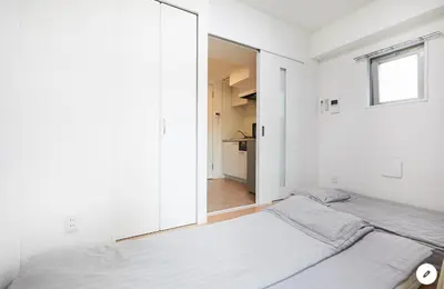 a bedroom with two beds and a mirror at Marvelous Kinshicho - Vacation STAY 12770v in Tokyo
