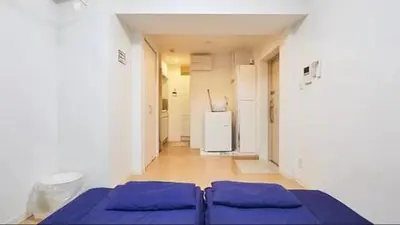 a room with two blue beds and a refrigerator at Marvelous Kinshicho - Vacation STAY 13097v in Tokyo