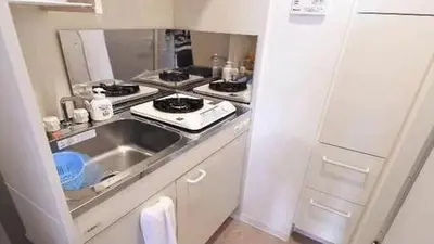 a small kitchen with a sink and a stove at Marvelous Kinshicho - Vacation STAY 13097v in Tokyo