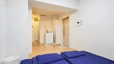 a white room with a bed and a refrigerator at Marvelous Kinshicho - Vacation STAY 13097v in Tokyo