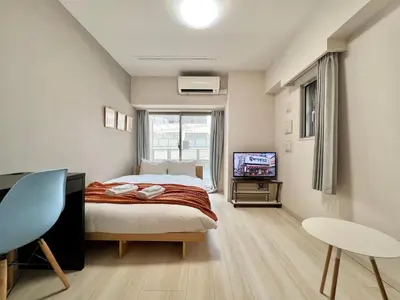 a bedroom with a bed and a television in it at Otsuka No3 Mansion #JR Yamanote Line#Fixed Wifi in Tokyo