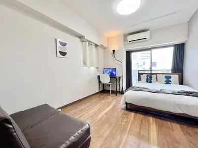 a bedroom with a bed and a couch and a desk at Otsuka No3 Mansion #JR Yamanote Line#Fixed Wifi in Tokyo