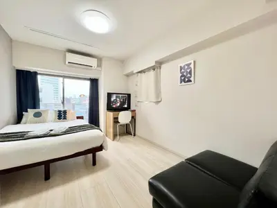 a bedroom with a bed and a chair and a window at Otsuka No3 Mansion #JR Yamanote Line#Fixed Wifi in Tokyo