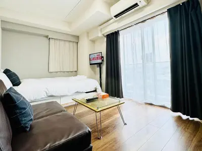 a living room with a couch and a coffee table at Otsuka No3 Mansion #JR Yamanote Line#Fixed Wifi in Tokyo