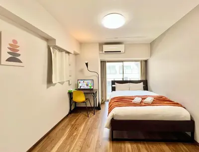 a bedroom with a bed and a desk in it at Otsuka No3 Mansion #JR Yamanote Line#Fixed Wifi in Tokyo