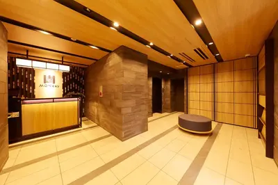 a lobby with a bench in the middle of a building at MONday Apart Asakusabashi Akihabara in Tokyo
