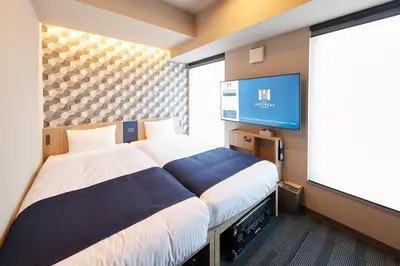 a hotel room with a bed and a flat screen tv at MONday Apart Asakusabashi Akihabara in Tokyo