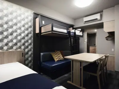 a bedroom with a bunk bed and a table and a desk at MONday Apart Asakusabashi Akihabara in Tokyo