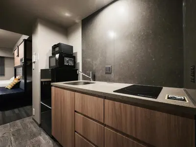 a kitchen with a sink and a microwave at MONday Apart Asakusabashi Akihabara in Tokyo