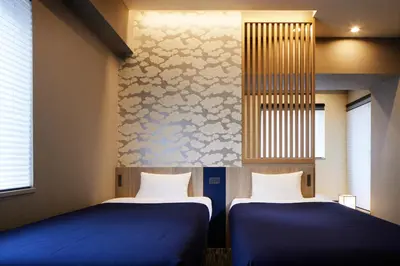 two beds sitting next to each other in a room at Minn Akihabara in Tokyo