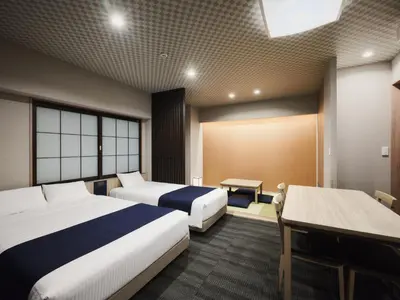 a hotel room with two beds and a table at MONday Apart Premium UENO OKACHIMACHI in Tokyo