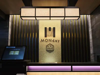 a lobby with a laptop and a monopoly sign at MONday Apart Premium UENO OKACHIMACHI in Tokyo