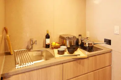 a kitchen counter with a sink and a stove at MONday Apart Premium UENO OKACHIMACHI in Tokyo