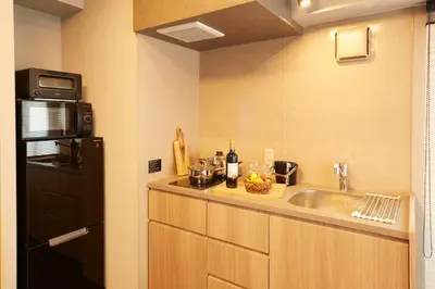 a kitchen with a sink and a microwave at MONday Apart Premium UENO OKACHIMACHI in Tokyo