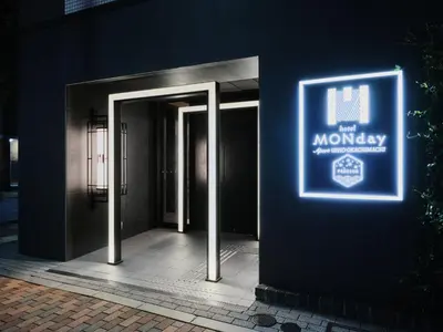 a sign on a building that says the monkey at MONday Apart Premium UENO OKACHIMACHI in Tokyo