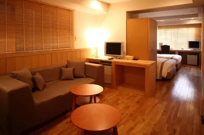 a living room with a couch and a bed at Sutton Place Hotel Ueno in Tokyo