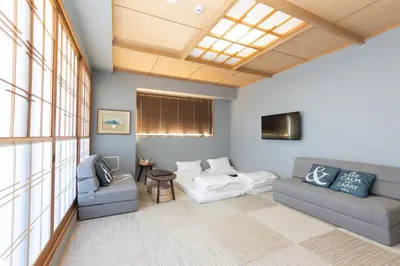 a living room with two couches and a tv at \u706f\u5149\u65c5\u9928 Light hotel in Tokyo