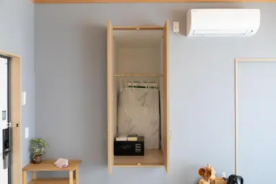a wooden shelf on a wall with a mirror at \u706f\u5149\u65c5\u9928 Light hotel in Tokyo