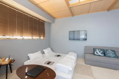 a living room with a couch and a table at \u706f\u5149\u65c5\u9928 Light hotel in Tokyo