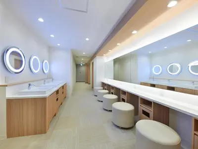 a bathroom with a row of sinks and mirrors at Smart Stay SHIZUKU Shinagawa-Oimachi in Tokyo