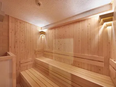 a sauna with wood paneling and a light on the wall at Smart Stay SHIZUKU Shinagawa-Oimachi in Tokyo