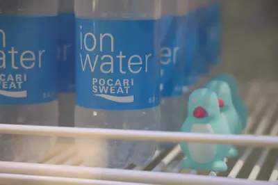 a shelf with two bottles of water and a toy at Smart Stay SHIZUKU Shinagawa-Oimachi in Tokyo