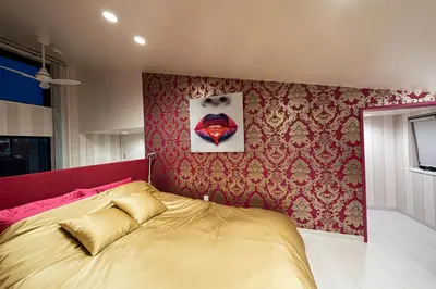a bedroom with a bed and a painting on the wall at La Krasse Skytree in Tokyo