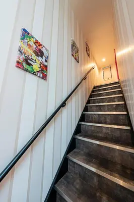 a set of stairs in a building with paintings on the wall at La Krasse Skytree in Tokyo