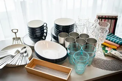 a table with plates and glasses and a wooden tray at La Krasse Skytree in Tokyo
