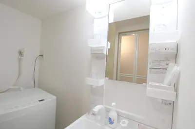 a white bathroom with a toilet and a mirror at Uhome\u5343\u99c4\u6728\u9759\u96c5\u6c11\u5bbf\u65c5\u9986 in Tokyo
