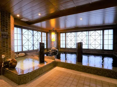 a swimming pool in a building with water at Dormy Inn Ikebukuro - Natural Hot Spring in Tokyo