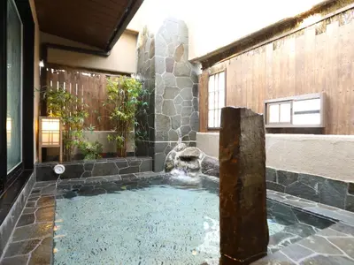 a swimming pool with a fountain in a building at Dormy Inn Ikebukuro - Natural Hot Spring in Tokyo