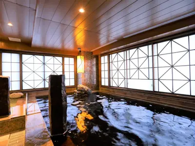 a room with a pond in the ceiling with windows at Dormy Inn Ikebukuro - Natural Hot Spring in Tokyo