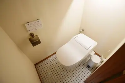 a small bathroom with a white toilet in a room at Meee Shinjuku in Tokyo