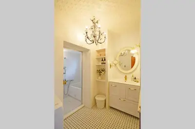 a bathroom with a chandelier and a sink at Meee Shinjuku in Tokyo