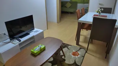 a living room with a television and a dining table at Isshuku Ryokan Asakusabashi - Vacation STAY 17363v in Tokyo