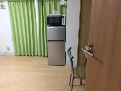 a room with a microwave on top of a refrigerator at Isshuku Ryokan Asakusabashi - Vacation STAY 17365v in Tokyo