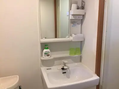 a bathroom with a sink and a mirror at Isshuku Ryokan Asakusabashi - Vacation STAY 17365v in Tokyo