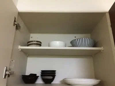 a bathroom with a shelf with bowls and a toilet at Isshuku Ryokan Asakusabashi - Vacation STAY 17365v in Tokyo