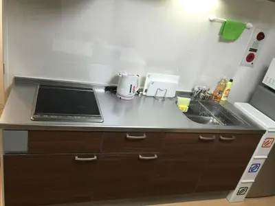 a kitchen counter with a sink and a stove at Isshuku Ryokan Asakusabashi - Vacation STAY 17353v in Tokyo