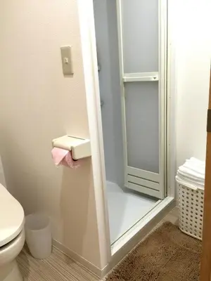 a bathroom with a toilet and a glass shower door at Isshuku Ryokan Asakusabashi - Vacation STAY 17353v in Tokyo