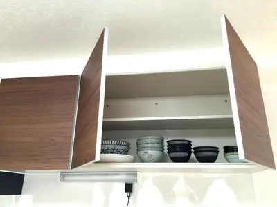 a cupboard with bowls and plates in it at Isshuku Ryokan Asakusabashi - Vacation STAY 17353v in Tokyo
